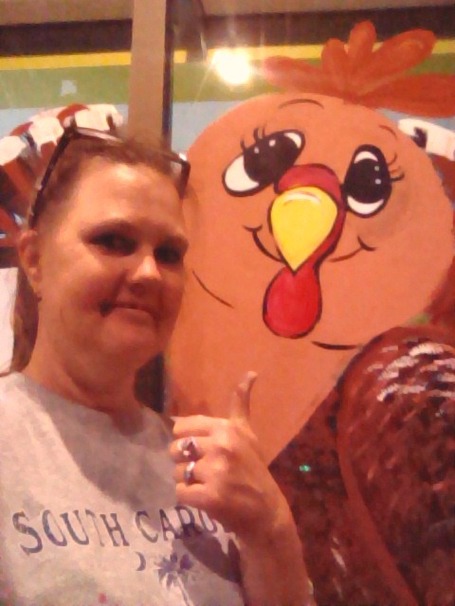 Artist M Burgess with Trixie Turkey - a Thanksgiving character